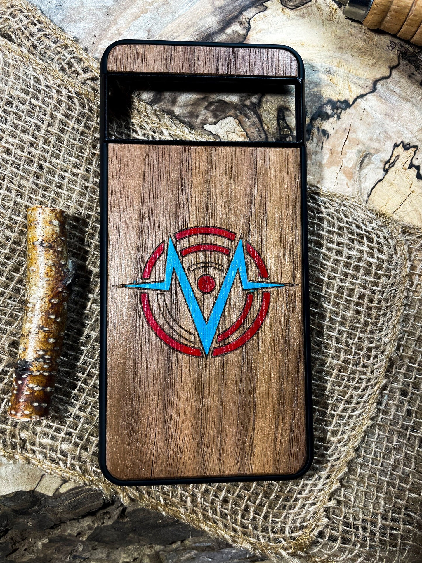 a wooden phone case with a blue arrow on it