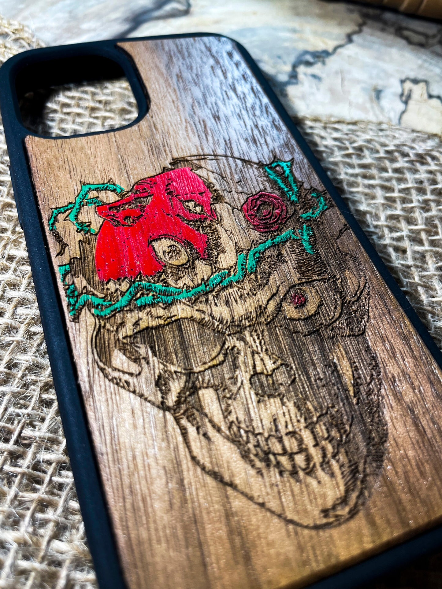 a wooden phone case with a picture of a skull on it