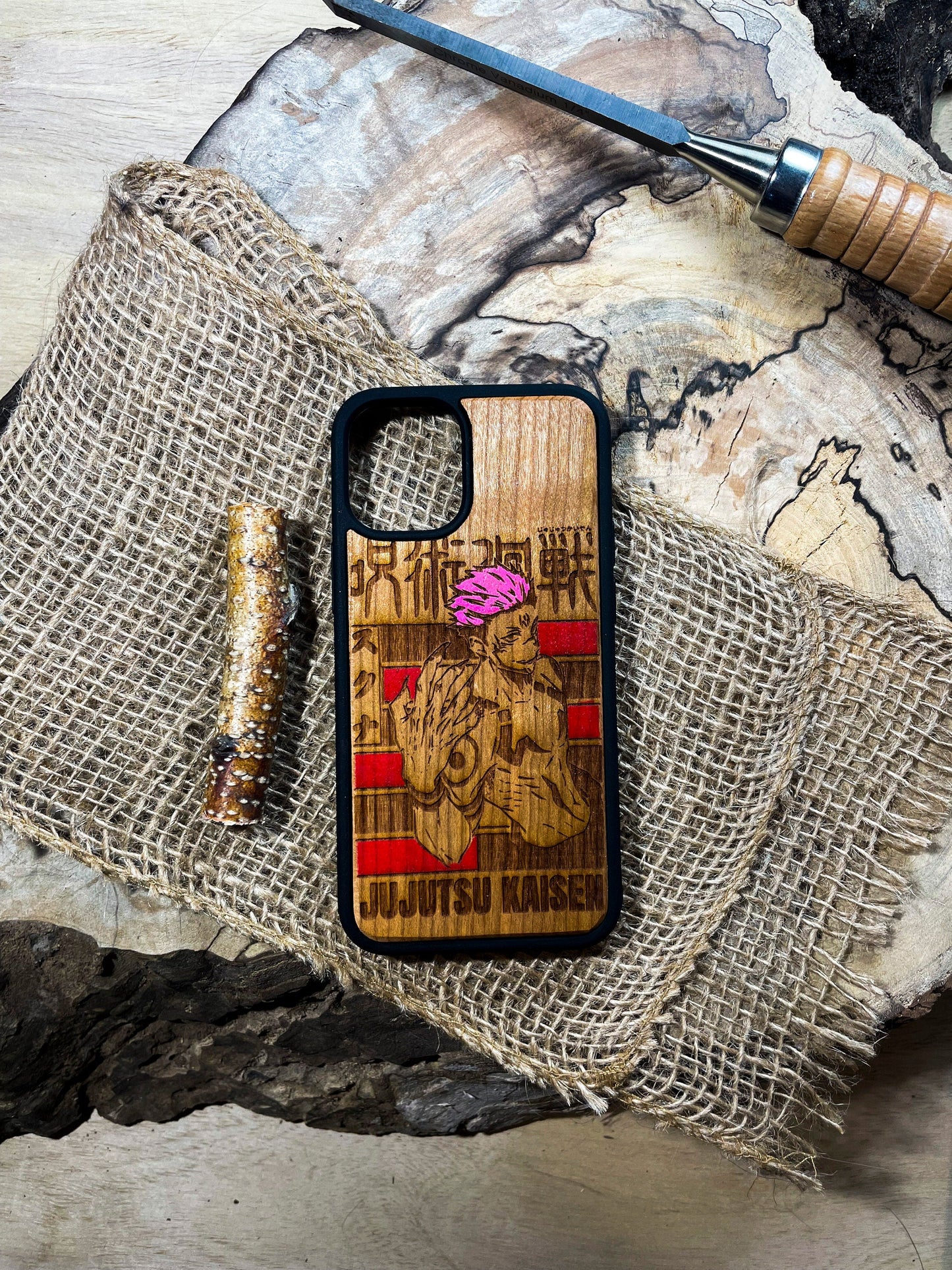 a wooden phone case sitting on top of a piece of wood