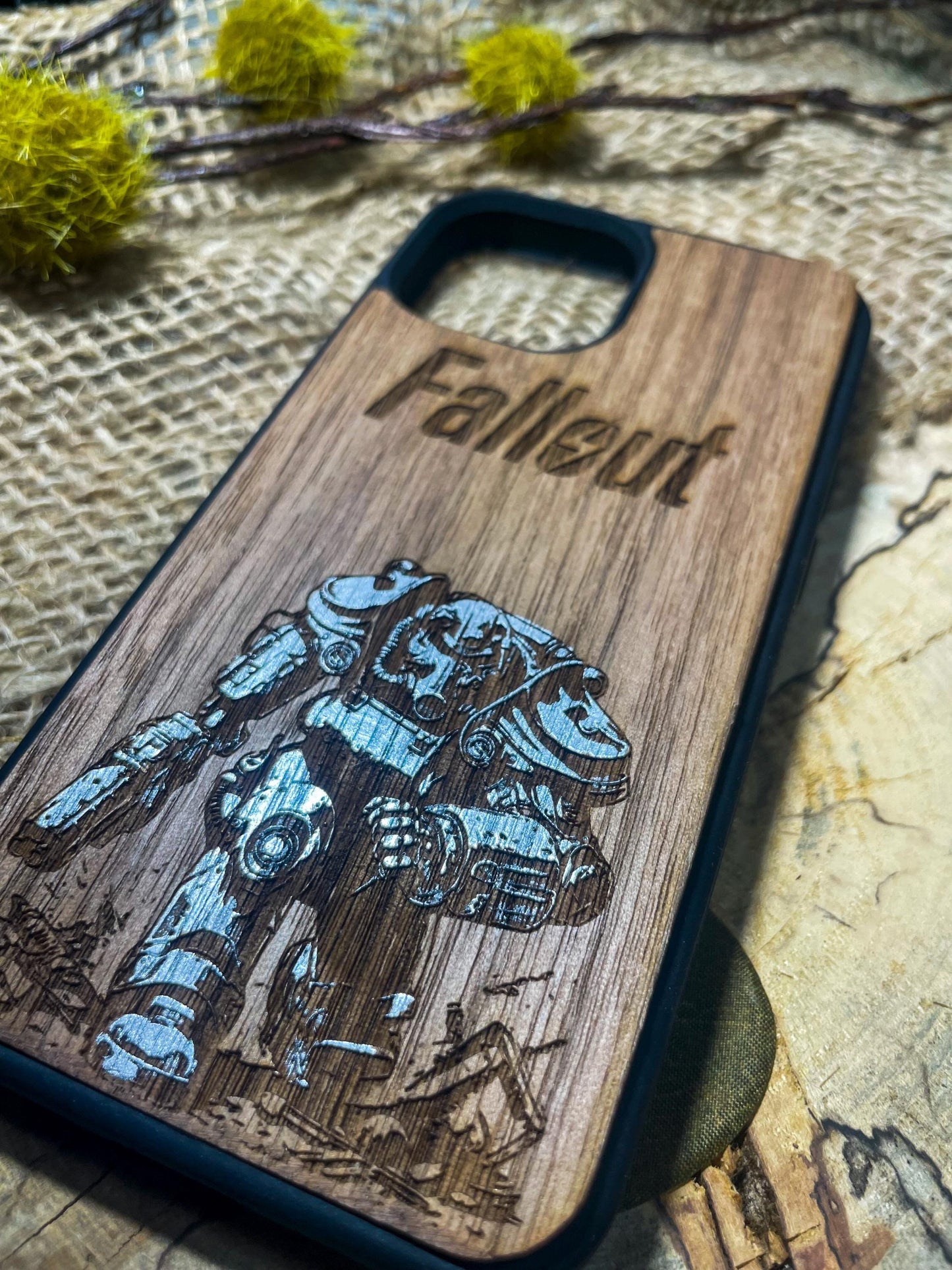 a wooden phone case with a picture of a robot on it