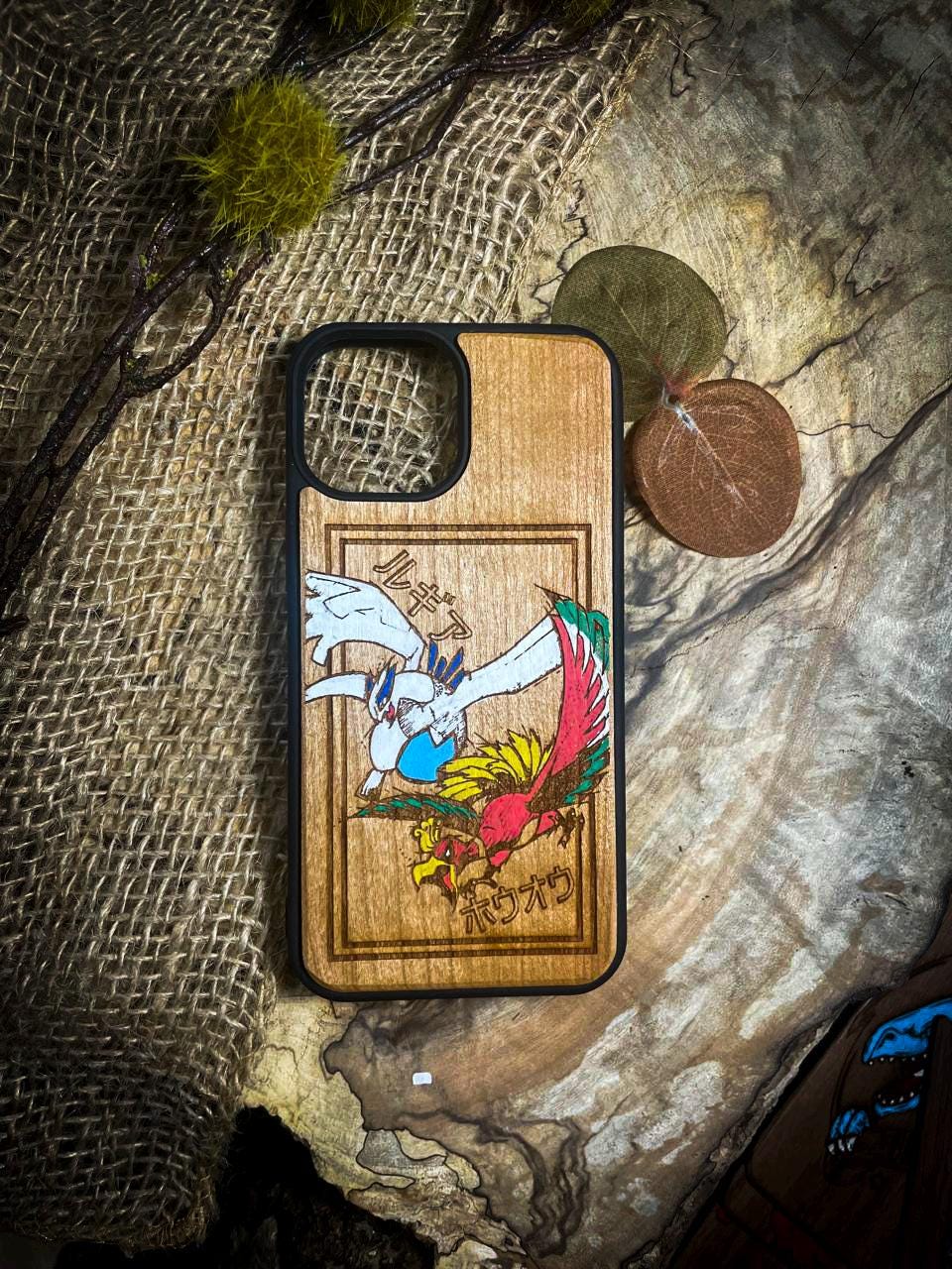 a wooden phone case with a picture of a bird on it