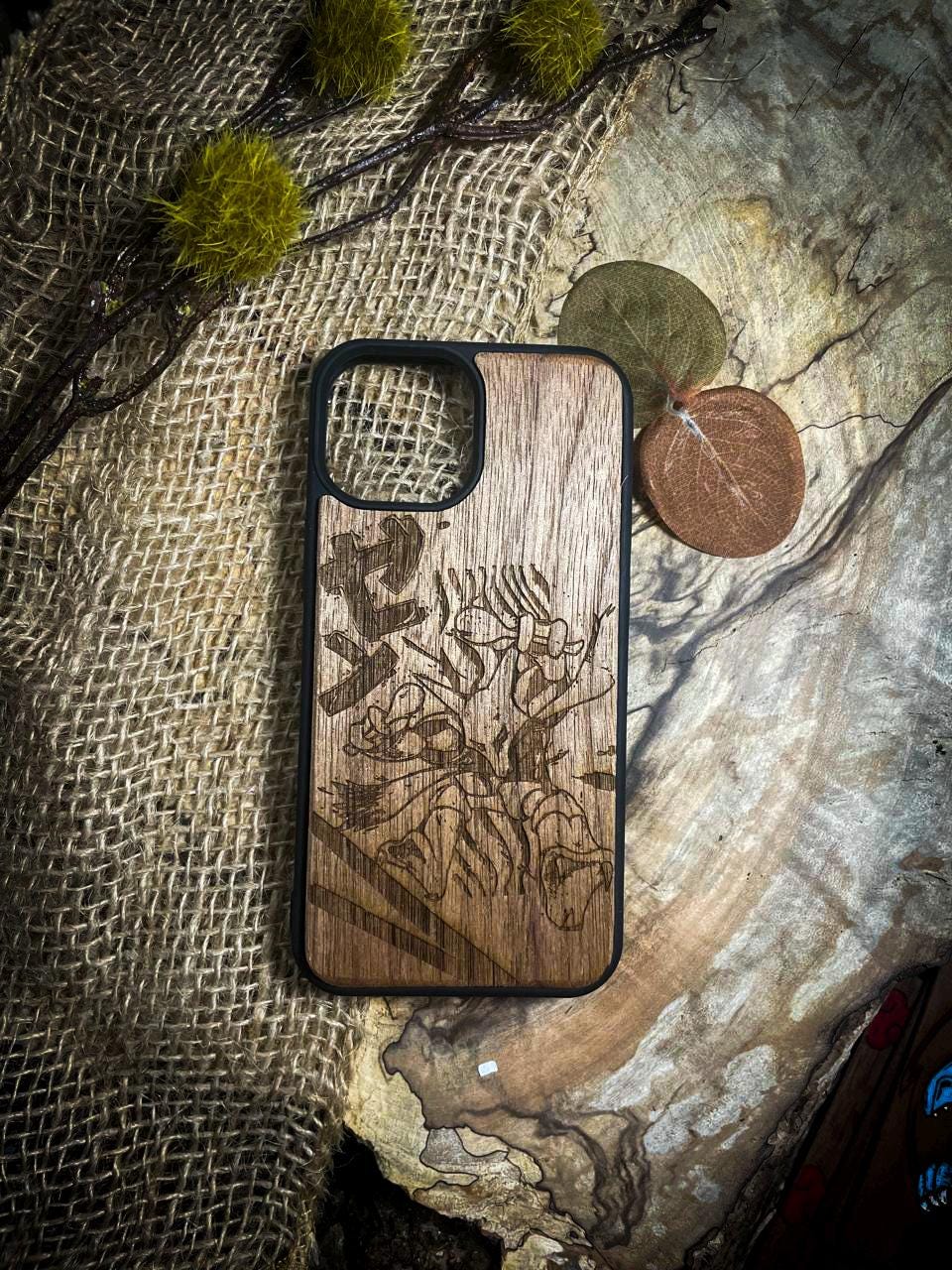 a wooden phone case sitting on top of a rock