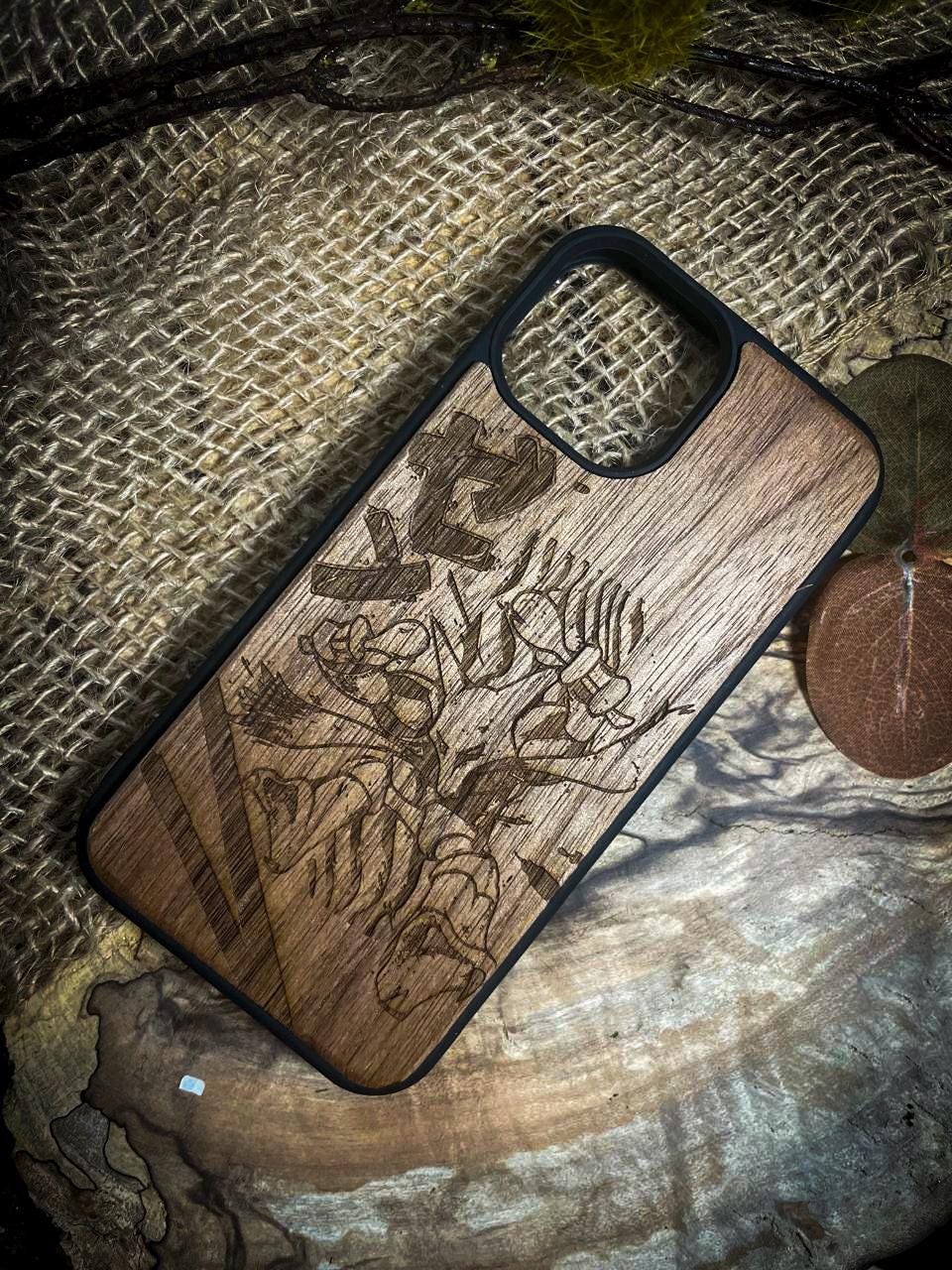 a wooden phone case sitting on top of a piece of wood