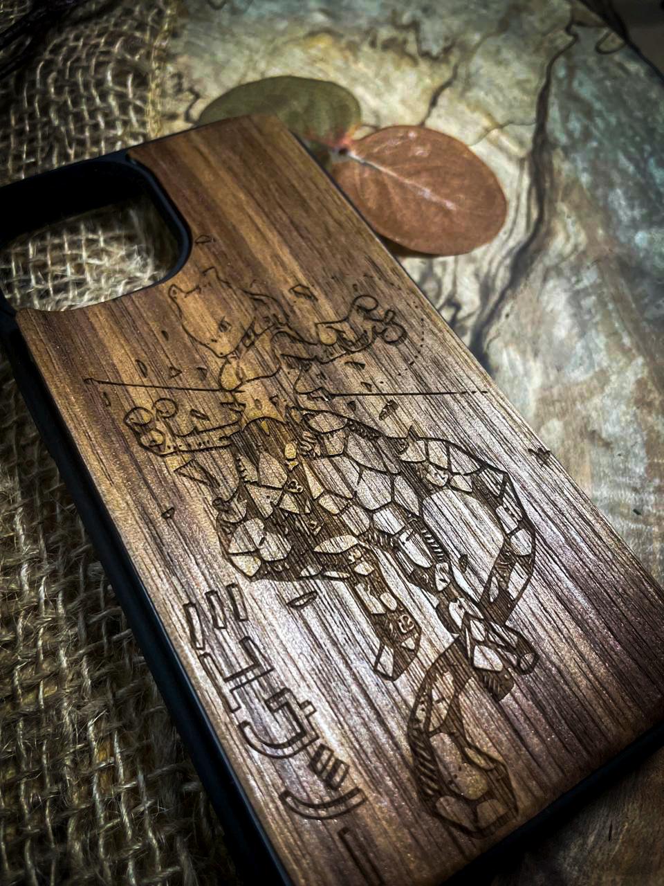 a wooden phone case with a drawing on it