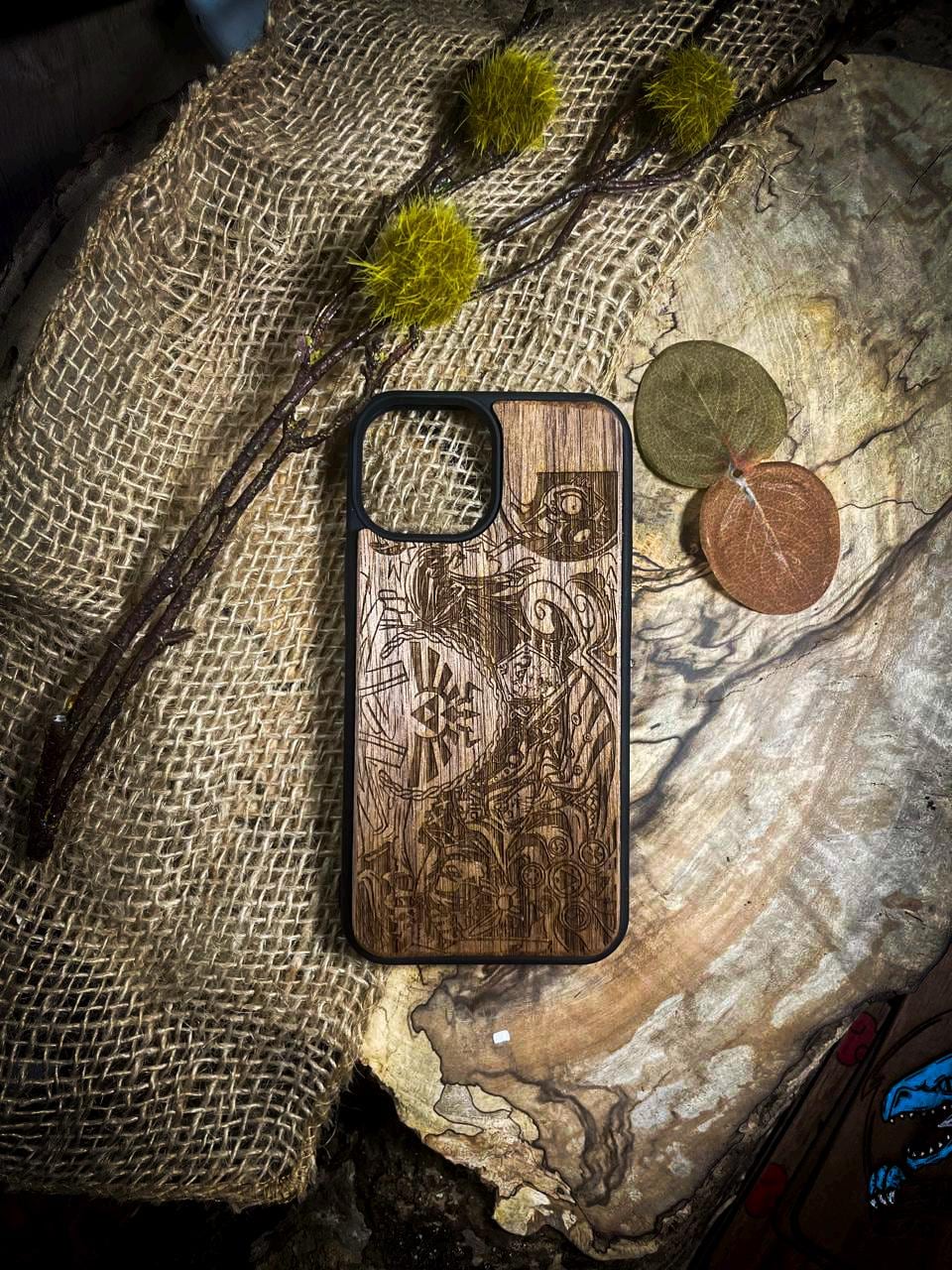 a wooden phone case sitting on top of a piece of wood