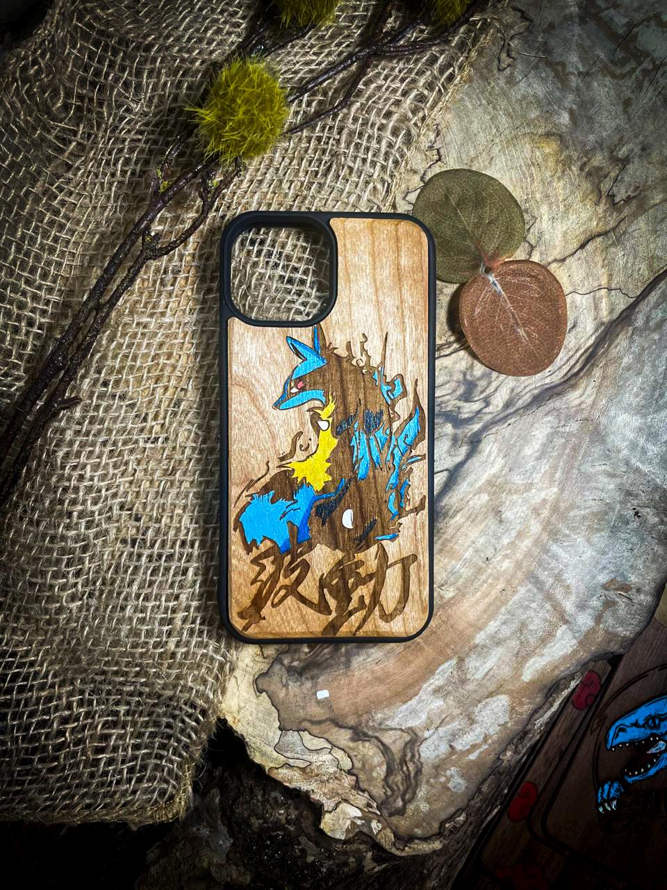 a wooden phone case with a picture of pokemon on it