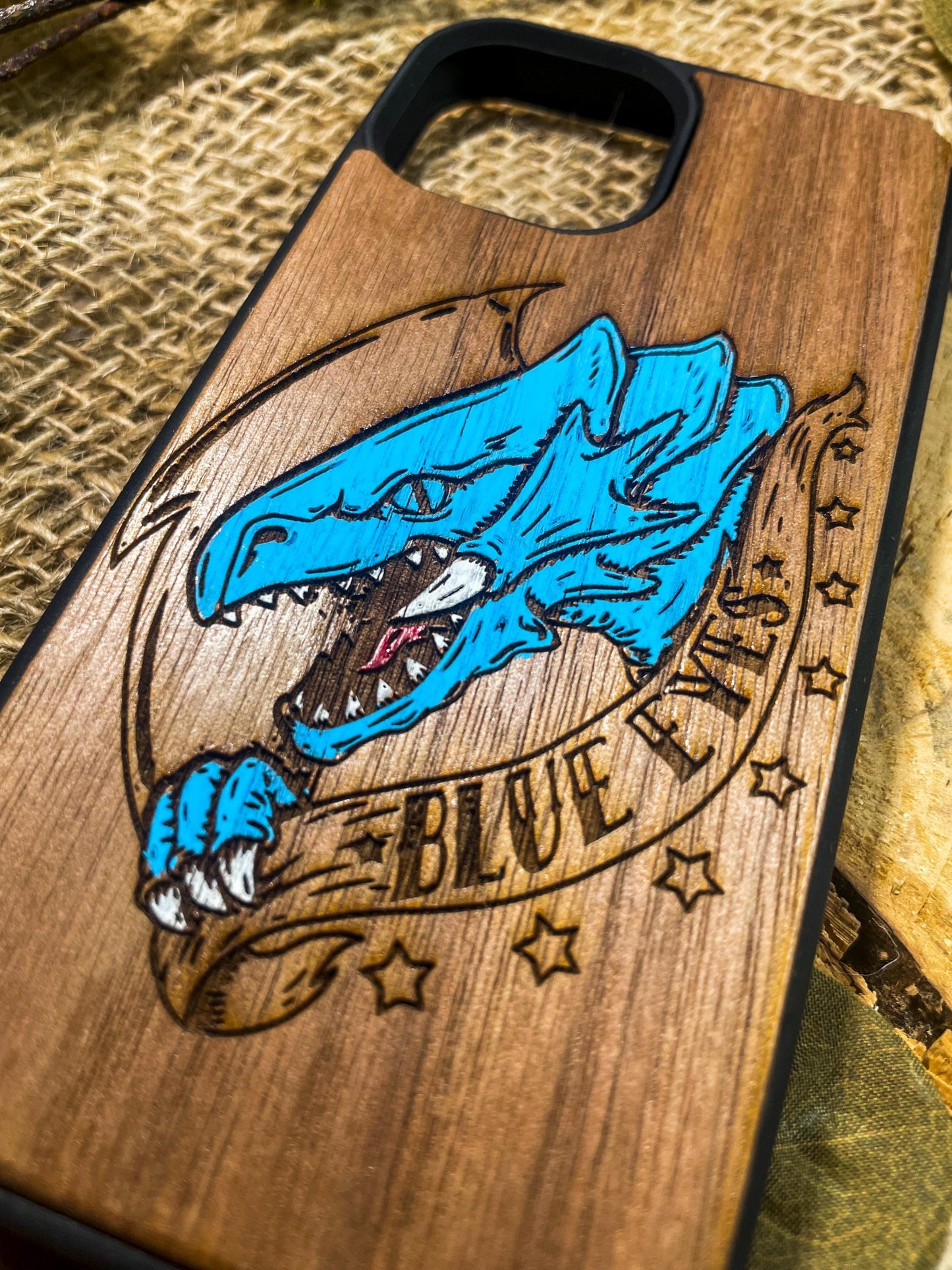 a wooden phone case with a picture of a blue jay on it