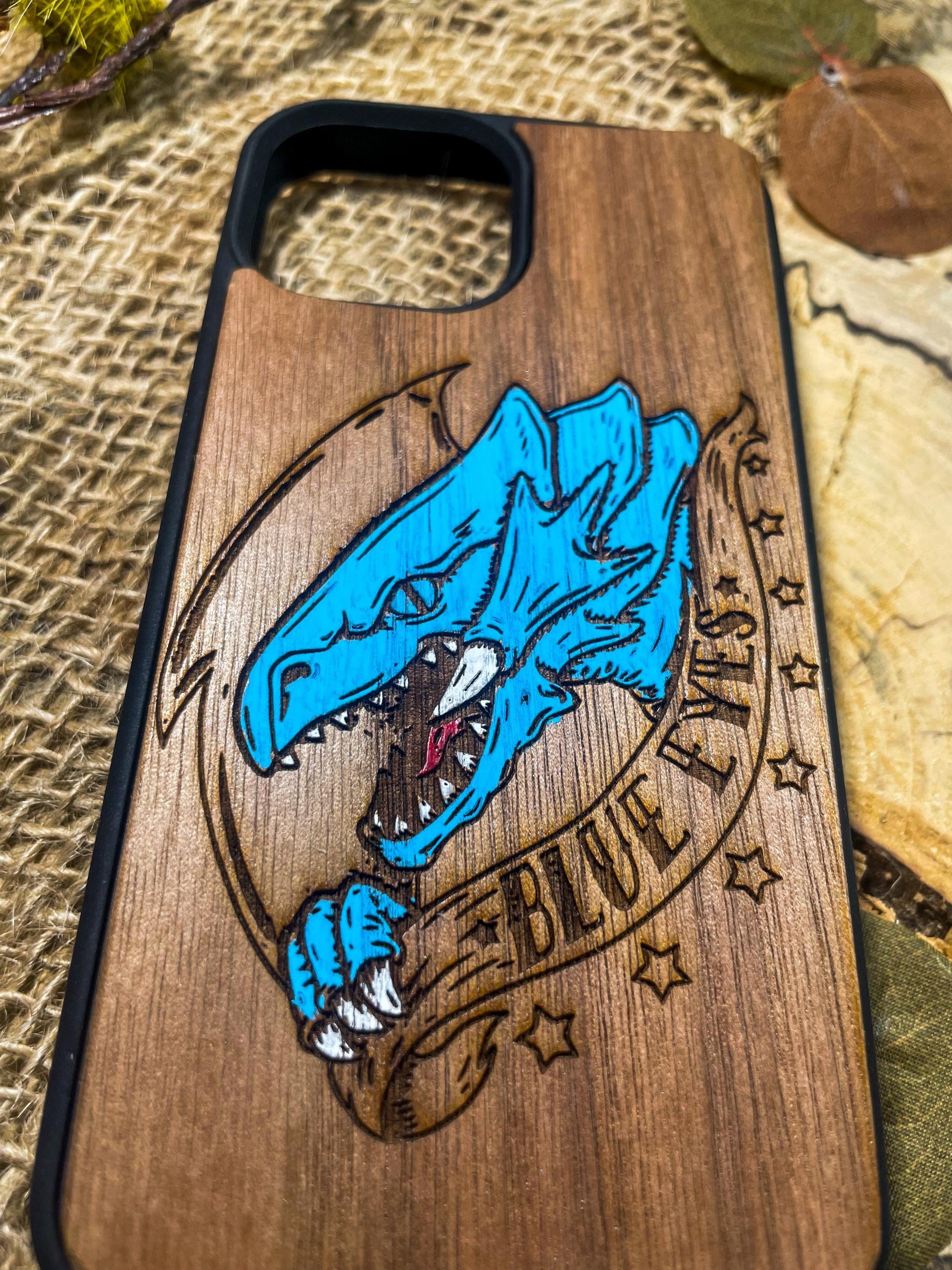 a wooden phone case with a blue dragon on it