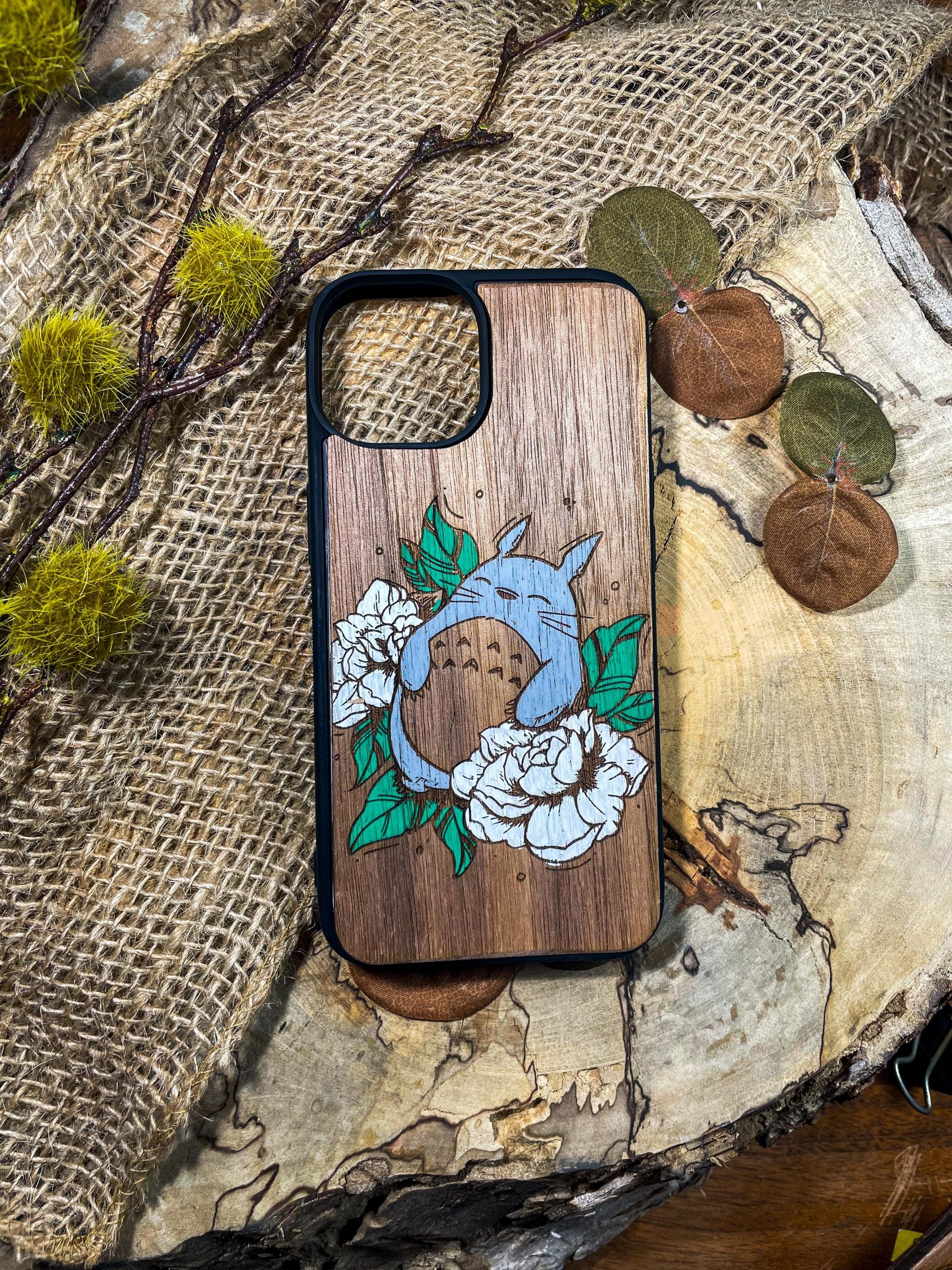 a wooden phone case with a picture of a dolphin on it