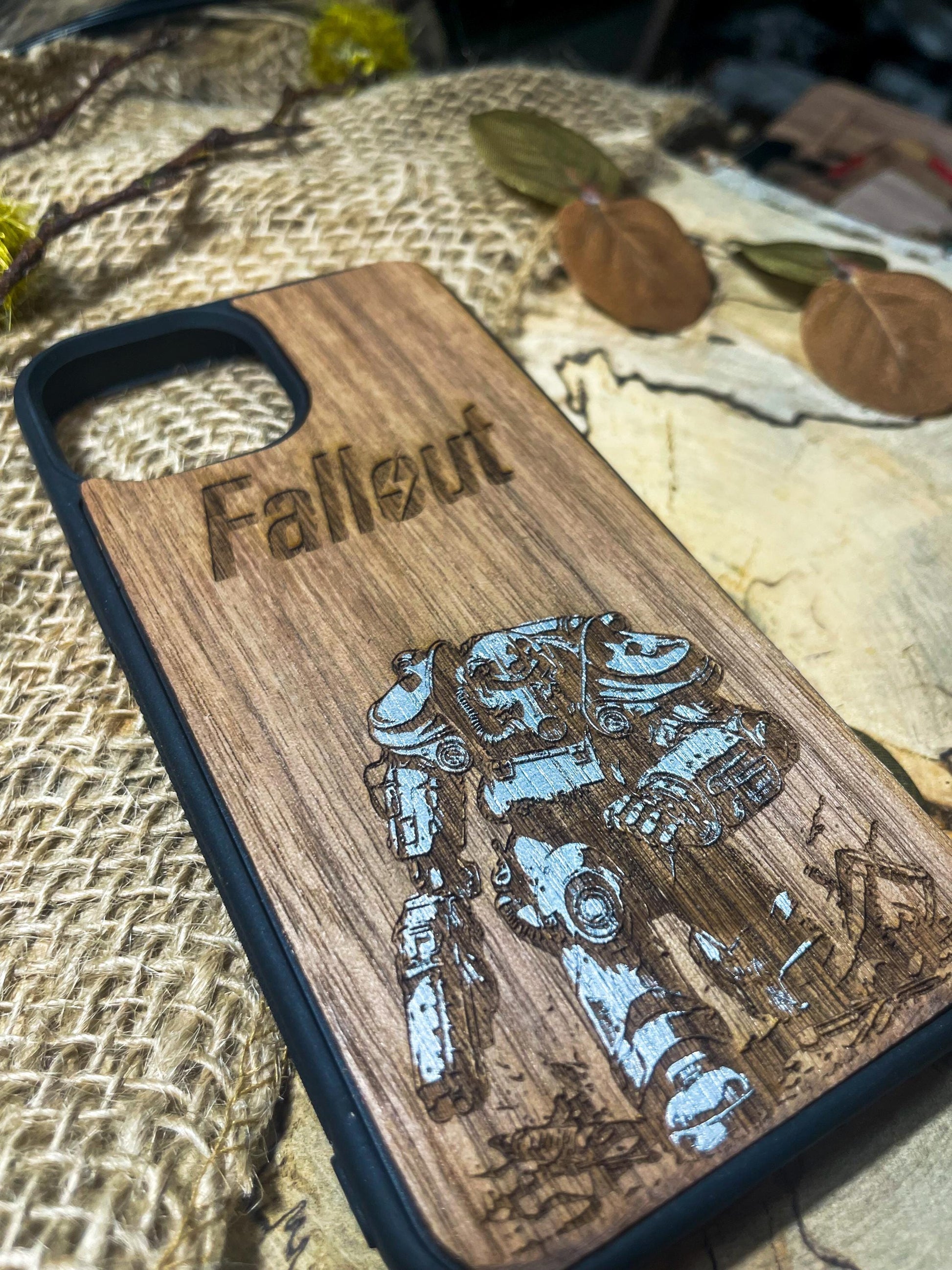 a wooden phone case with a picture of a robot on it