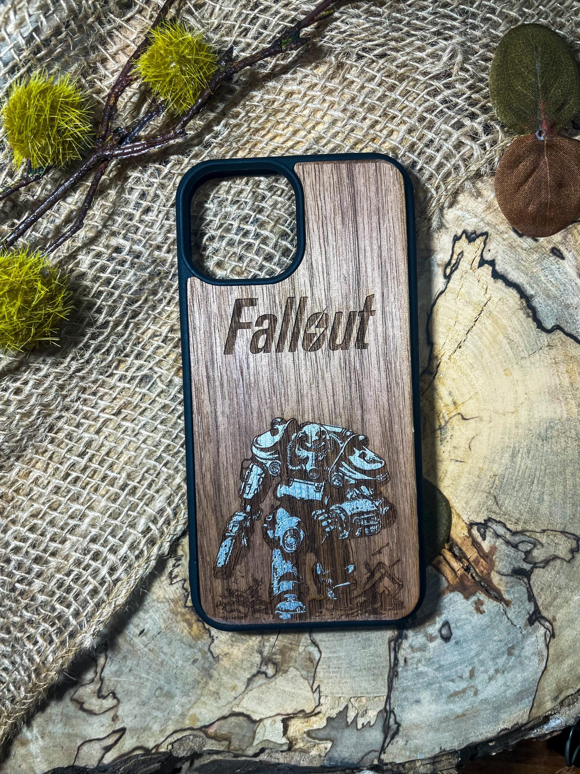 a wooden phone case with a picture of a robot on it