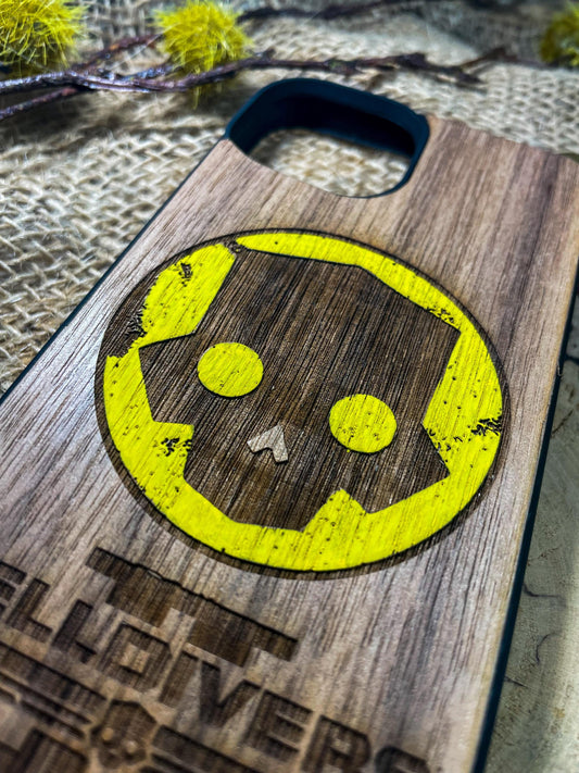 a wooden phone case with a smiley face on it