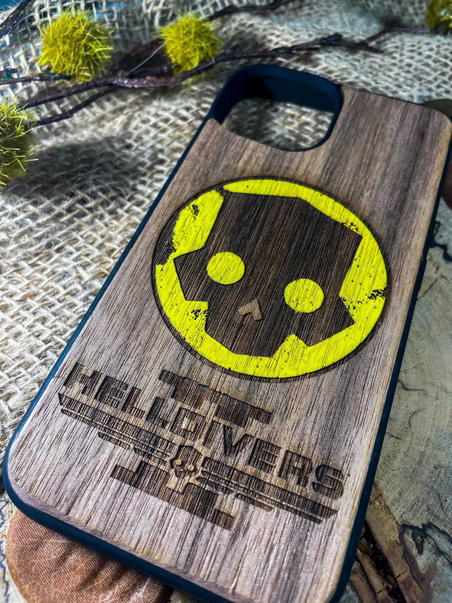 a wooden phone case with a smiley face on it