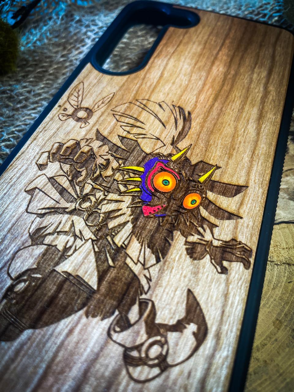 a wooden phone case with a picture of a demon on it