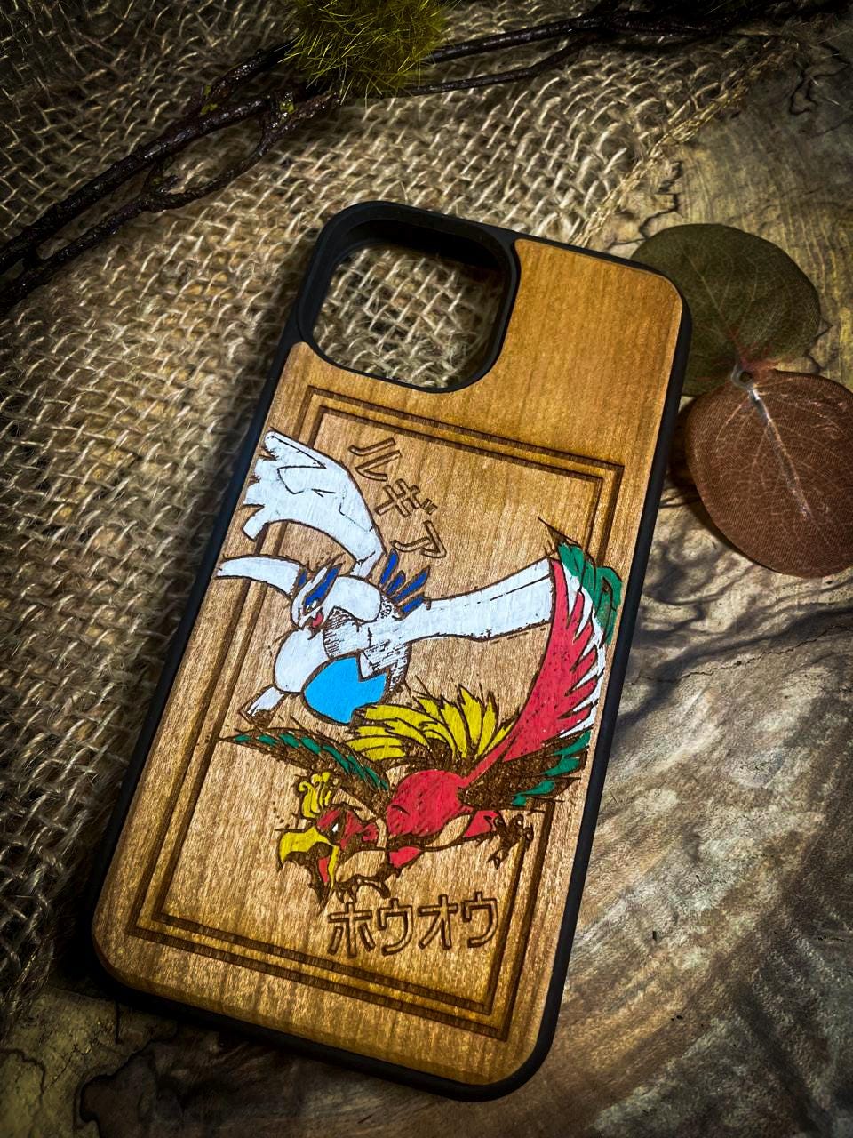 a wooden phone case with a picture of a bird on it