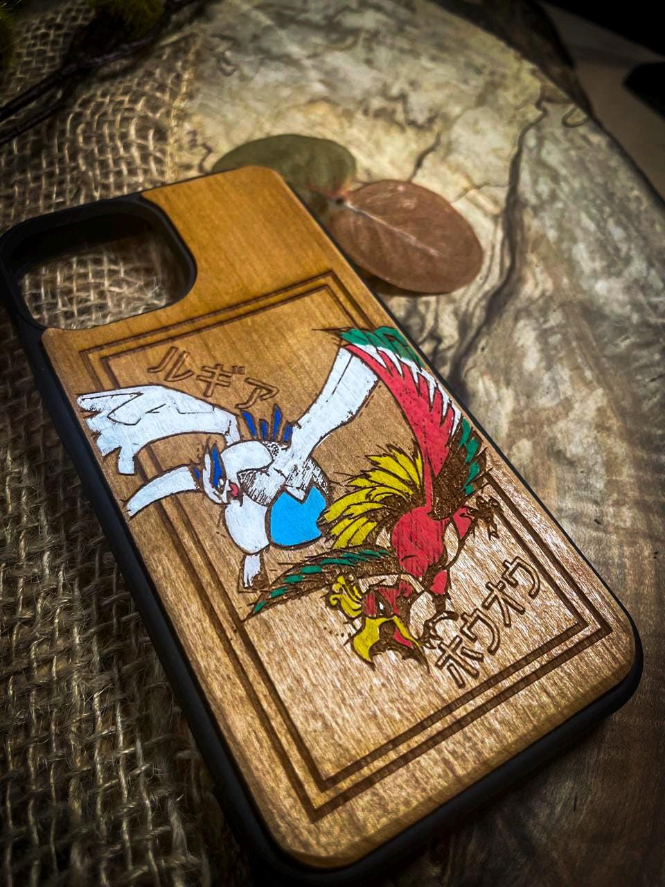 a wooden phone case with a picture of pokemon on it