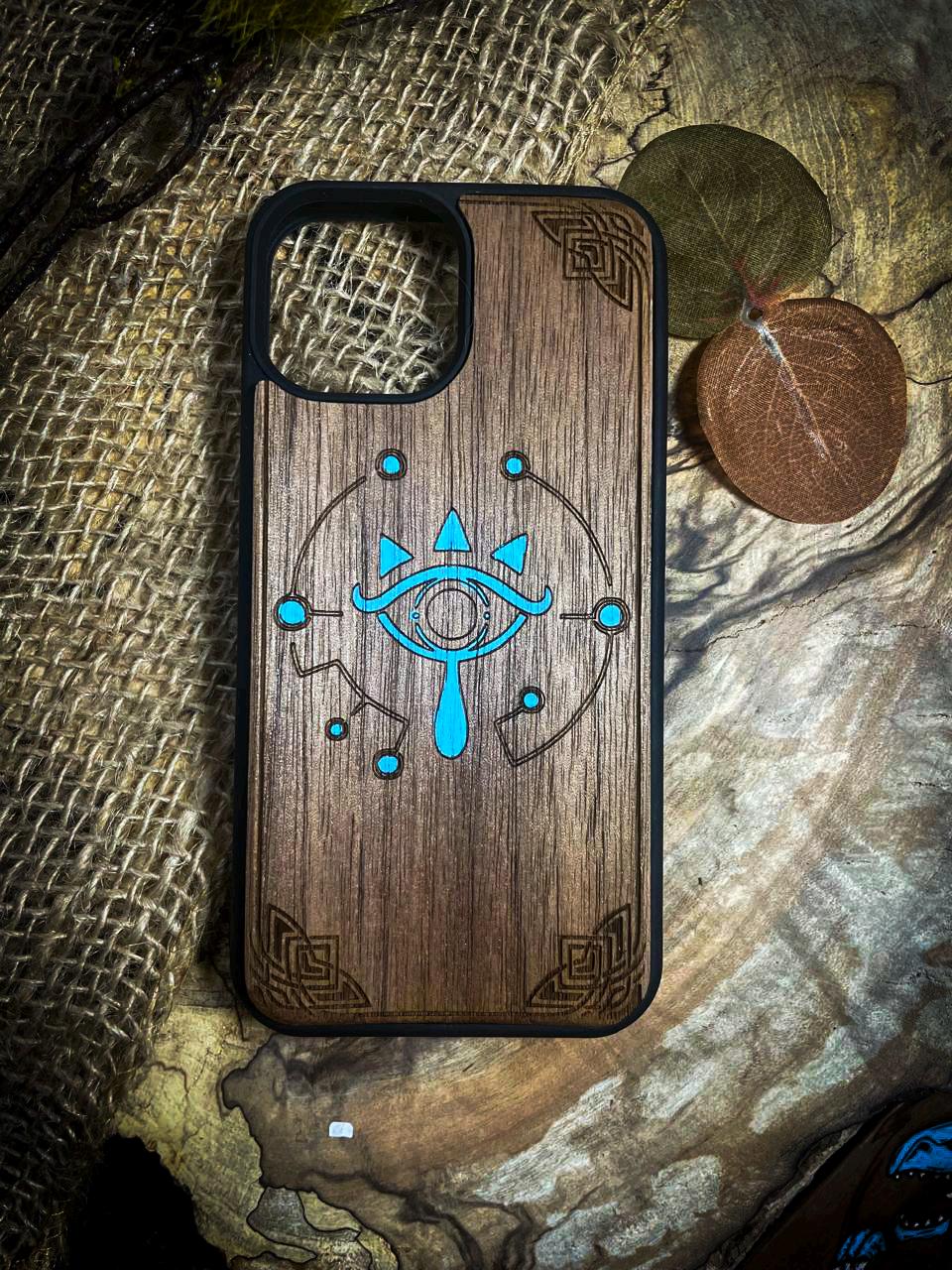 a wooden phone case with an eye on it