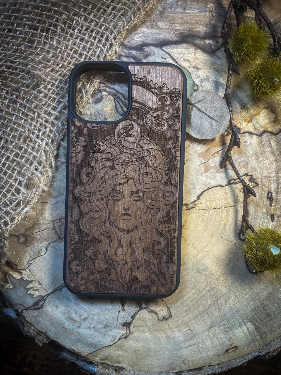 a wooden phone case sitting on top of a tree stump