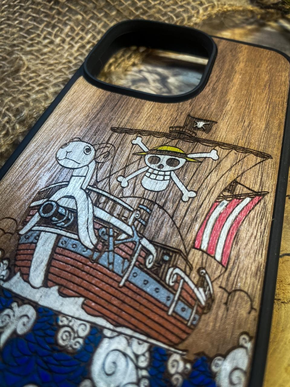 a wooden phone case with a picture of a pirate on it