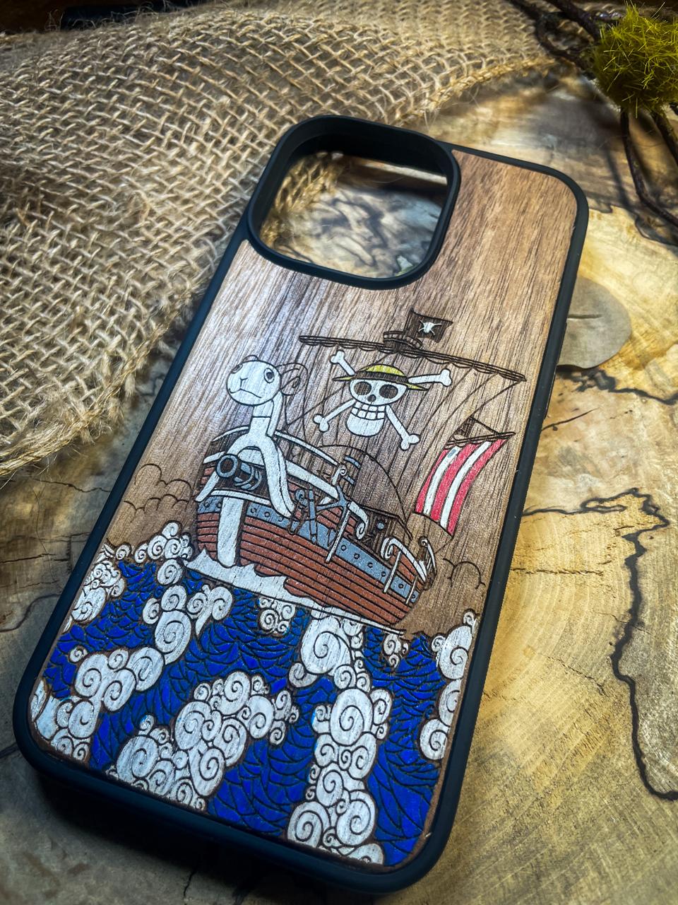 a wooden phone case with a picture of a pirate ship